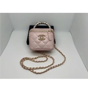 Mini Light Pink Quilted Vanity Bag with Pearl Handle and chain.